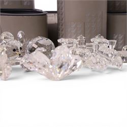 Collection of Swarovski crystal ornaments including train set, paperweight, towered building and many animal figurines, mostly in original boxes