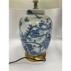 Pair of Chinese table lamps of baluster form, each decorated with landscape scene, raised upon gilt circular base, including shade H63cm