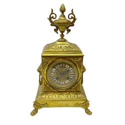  Late 19th century French gilt metal mantel clock, case with cast urn, foliage and lion mask handles, brass dial with Roman numeral porcelain cartouches 8-day movement stamped 'HP & Co' striking the house and half on bell H36cm   