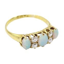 Early 20th century 18ct gold three stone opal, the centre stone set with two old cut diamonds either side, London 1913, total diamond weight approx 0.30 carat
