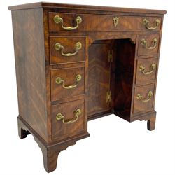 George III design rosewood kneehole desk, rectangular top with moulded edge, fitted with single frieze drawer and six graduating mahogany lined short drawers, each with cock-beaded facias, the central recessed cupboard enclosing single shelf, lower moulded edge over shaped bracket feet, stamped 'G Burton' to inner drawer