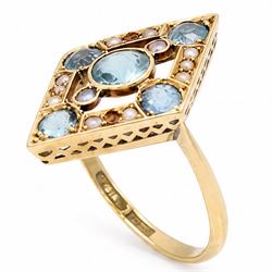 Early 20th century gold blue stone and split pearl diamond shaped ring, five milgrain set round cut stones possibly zircon or aquamarines, with seed pearl surround in a pierced design setting, stamped 18ct 