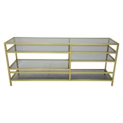 Modern glass and gilt metal media stand, rectangular smoked glass top panel set within a gilt finished metal surround, raised on square section legs, the underside fitted with a full-width glass shelf