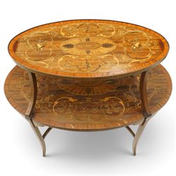 Edwardian Sheraton Revival inlaid mahogany and satinwood marquetry oval two-tier étagère occasional table, the oval top with removable glazed tray with brass handles, over an ornately inlaid top with central patera motif and trailing foliate scrolls, the splayed uprights inlaid with bellflowers, over a matched inlay under-tier, raised on splayed supports united by curved X-stretcher,  retailed by David Hick Interiors, Jersey