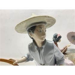 Lladro figure group, Rickshaw ride, modelled as a gentleman in blue dress pulling a rickshaw carrying a lady with a parasol, no 1383, H30cm