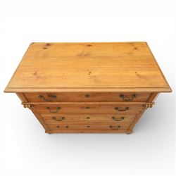 Late Victorian pine chest of drawers, the moulded top above four long drawers with brass drop handles and flower head escutcheons, flanked by pilasters, upon four turned compressed bun feet, 89cm x 103cm x 54cm
