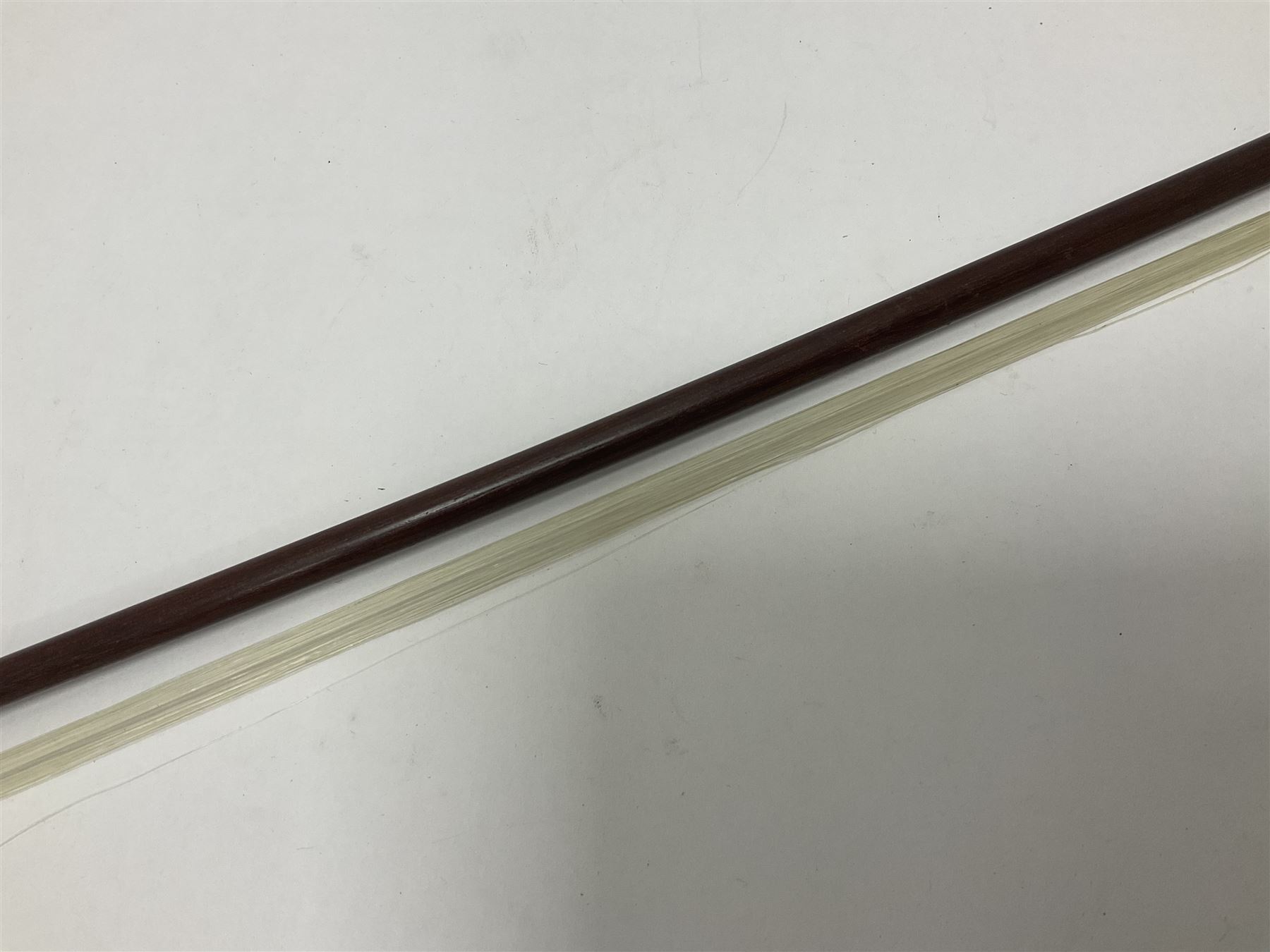19th century wooden violin bow with a decorative mother of pearl inlay depicting flowers to the frog, with a bone adjuster screw