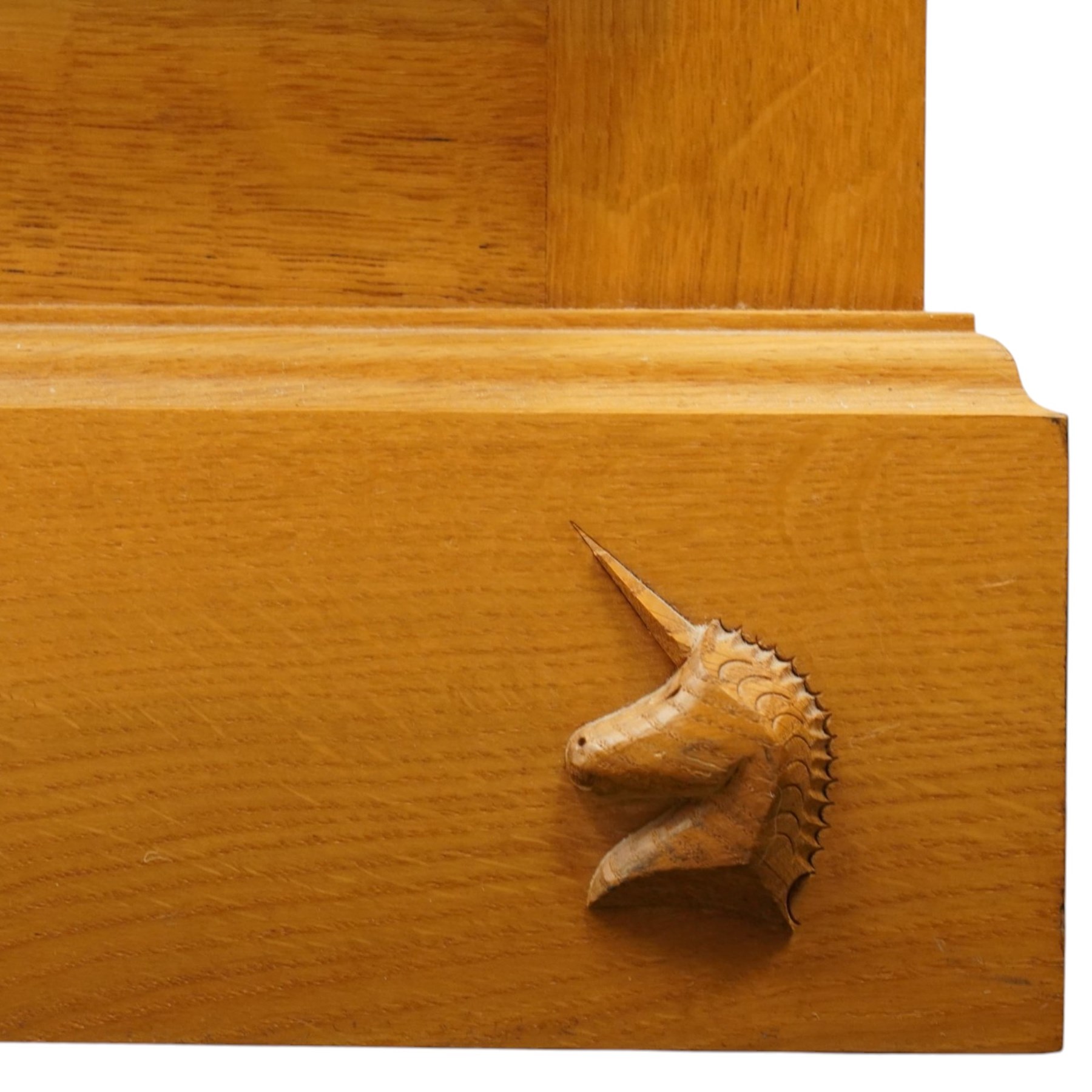 Unicornman - craftsman made oak low-cupboard or sideboard, rectangular top with raised back, fitted with four panelled cupboard doors, on skirted base applied with carved unicorn signature, by Geoff Gell of Coxwold