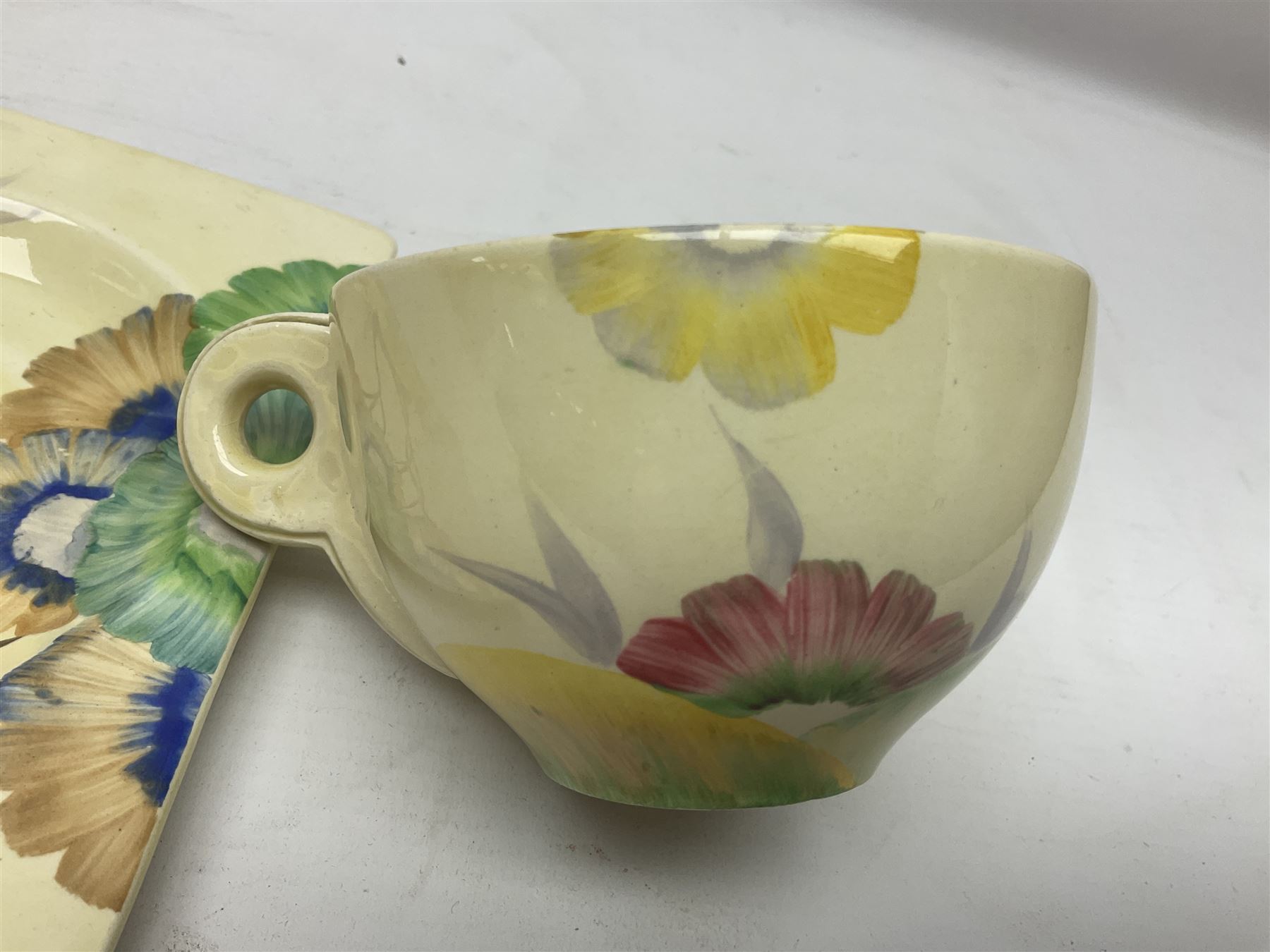 Clarice Cliff Biarritz for Royal Staffordshire/Wilkinson Ltd, teacup, saucer and side plate, in Viscaria pattern, the plate and saucer of rectangular form, each with printed mark beneath