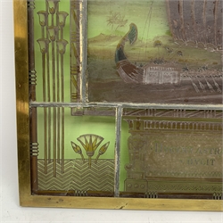 19th century leaded stained glass panel of maritime interest with central painted scene of a longboat being rowed down a river with palm trees in the distance, above a Latin motto ' Ducunt Astra Naves Deus/ Ducit Astra', with heiroglyphs and stylised flowers to the border 41 x 50.5cm including brass frame