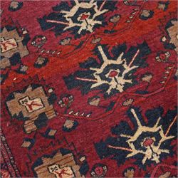 Afghan red ground rug, the field decorated with stylised plant motifs, within multiple borders (137cm x 105cm); together with a Caucasian red ground rug decorated with three Gul motifs (123cm x 85cm)