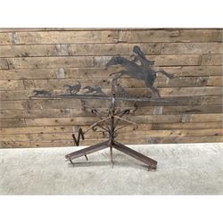 Black painted wrought iron weather-vane depicting hunting scene and compass points