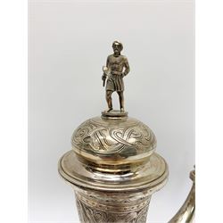 Late 19th century Danish silver drinking horn and cover, the body with hexagonal and beaded finial, raised upon two talon feet and further scroll foot, chased with scrolling foliate and zoomorphic bands, the detachable domed cover with conforming decoration surmounted by a figure holding a hammer, the cover interior impressed with maker's mark (partly worn and indistinct), alongside Danish Three Towers mark for 1881, with the Assay Master mark for Simon Groth (1863-1904), H23.5cm, weight 14.75 ozt (459 grams)

