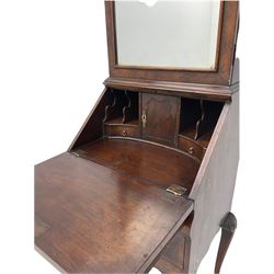 Small early 20th century Queen Anne style bookcase on bureau secretaire, the moulded arched pediment over mirrored door in shaped frame, the bureau fitted with fall front enclosing curved fitted interior, cushion moulded drawer over single drawer, on scroll and shell carved cabriole supports