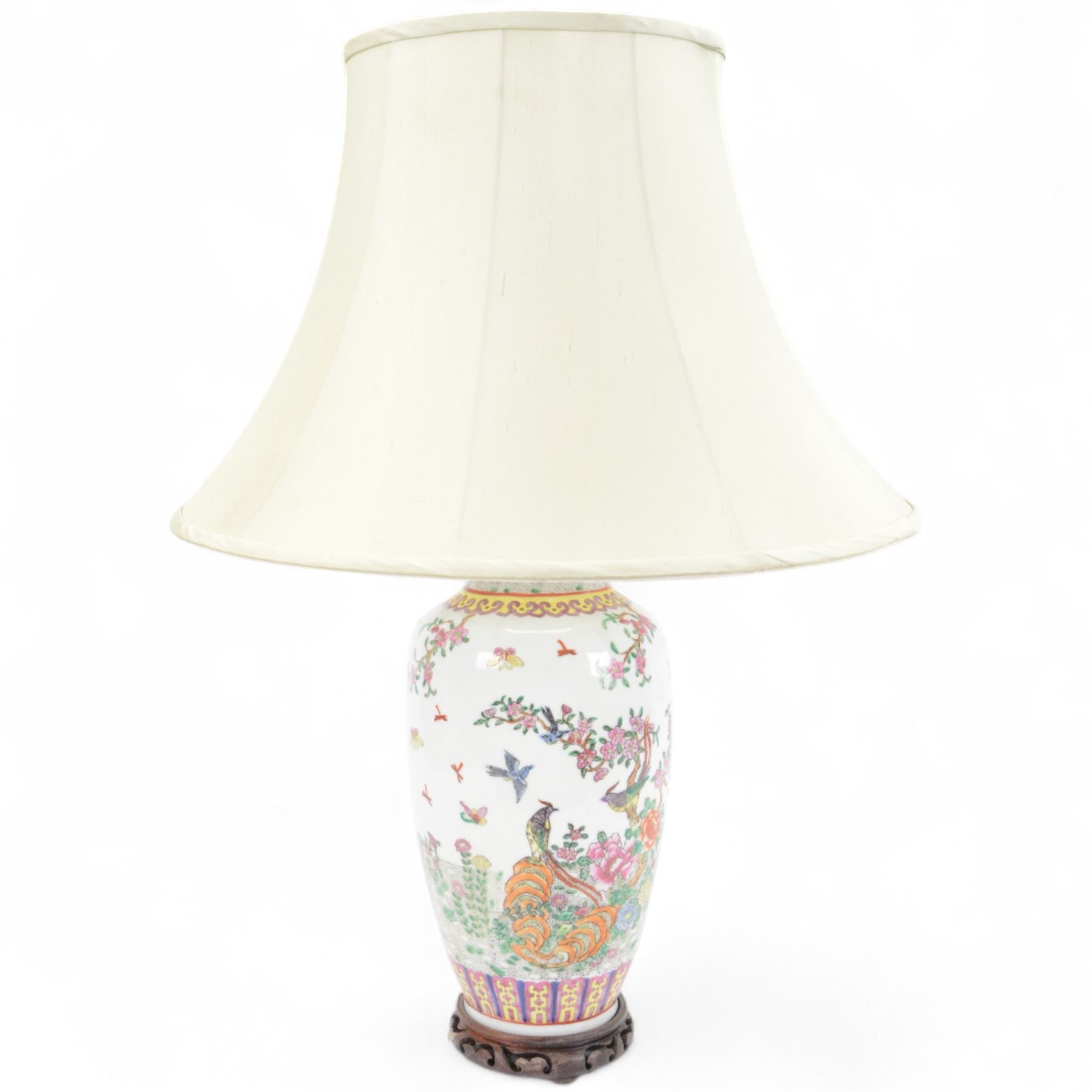 Chinese famille rose table lamp, of baluster form, decorated with birds in blossoming branches, upon a circular wooden base with shade, H78cm