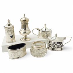 Silver three piece oval condiment set with engraved decoration Birmingham 1961, pierced silver mustard pot Chester 1901, silver pepperette and silver mounted glass salt