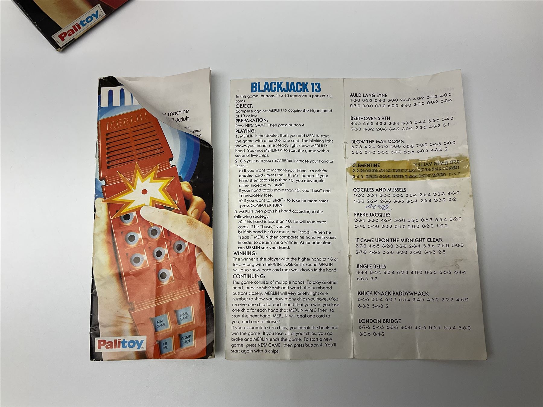 Three late 70s/early 80s handheld electronic games; Bandai Electronics Arcade ‘Gunfighter’ (1980), Grandstand ‘Invader From Space’ (1980), Palitoy ‘Merlin The Electronic Game Machine’ (1979) with game sheet and instruction booklet, all with original boxes (3) 