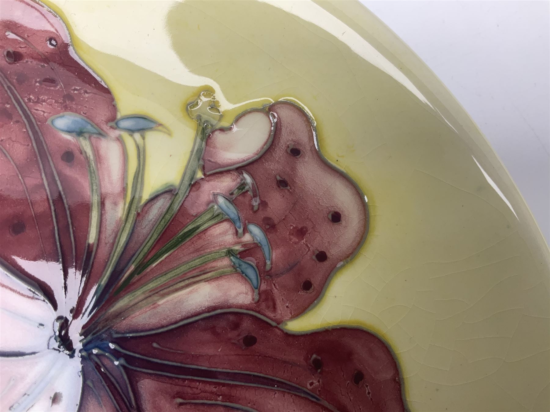 Moorcroft Tiger Lily pattern plate on a yellow ground, with painted and impressed mark beneath, D26cm