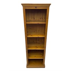 Narrow pine open bookcase, projecting moulded cornice over four open shelves, on plinth base
