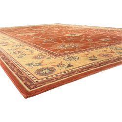 Late 20th century Royal Keshan 'Agra' hand-knotted wool rug, terracotta ground with central floral medallion and scrolling vines, enclosed by a cream border with repeating floral motifs