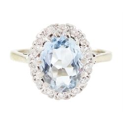 White gold aquamarine and diamond cluster ring, oval cut aquamarine of approx 1.35 carat, with single cut diamond surround, stamped 18ct
