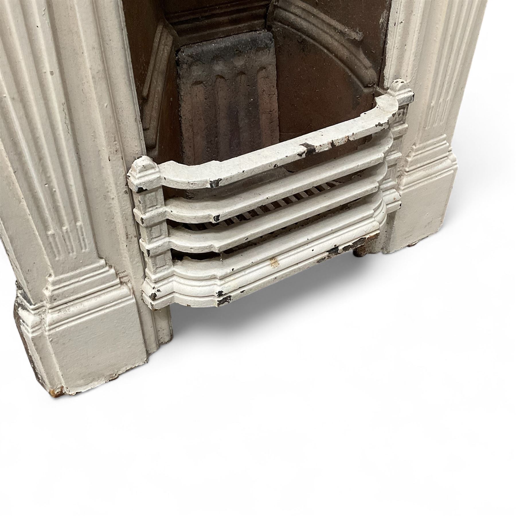 Two Victorian small cast iron fireplaces in a white finish