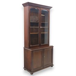 20th century mahogany display bookcase, projecting moulded cornice over a pair of glazed d...
