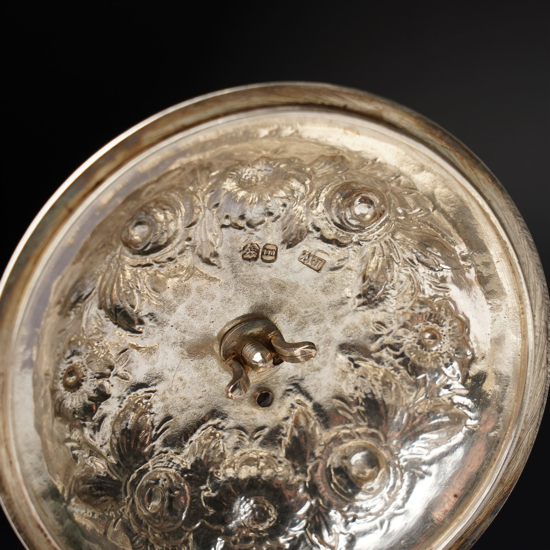 Matched three piece silver tea set comprising teapot of squat circular form London 1827,  milk jug of similar date and sugar bowl with Britannia standard marks, all with later embossed floral decoration and coat of arms, all marks rubbed