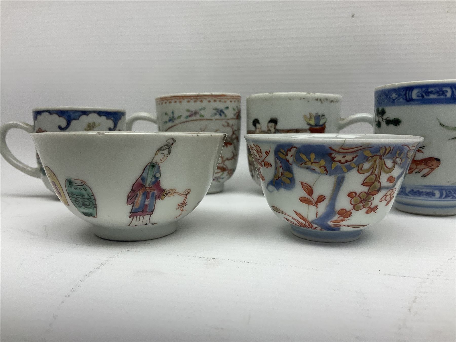 Two 18th century Chinese Yongzheng coffee cups, the first example decorated in polychrome enamel with rooster amidst blossoming peonies, the second decorated with deer and crane among rockwork and pine tree, together with two further 18th century Chinese coffee cups, an 18th century Chinese tea bowl, and a further tea bowl