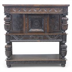 Jacobean revival oak side cabinet, rectangular top above carved frieze of stylised foliage and lunettes, fitted with a central cupboard doors with applied carved panels, above a frieze drawer, supported on turned and carved vase-shaped supports, united by stretcher tier and lower shelf
