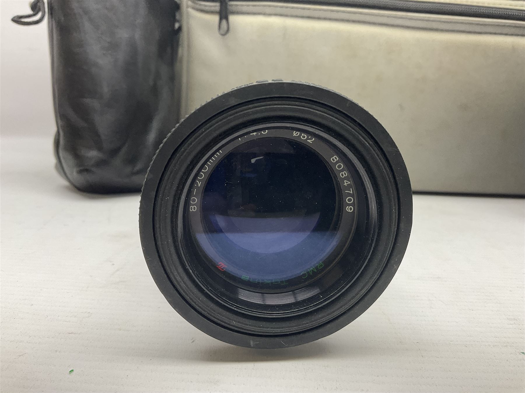 Canon A1 35mm camera body serial no 741264, with 'Tokina AT-X 28-85mm 1:3.5-4.5' lens serial no 821679, 'Canon FD 50mm 1:1.8mm' lens and other camera equipment 