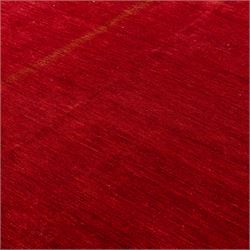 Two contemporary Moroccan Berber hand-woven rugs, deep madder red field of plain design, 199x153cm, other with deep madder red field with a simple lattice of ivory lines forming panels with some tonal variation, 190x146cm 