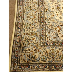  Kashan beige ground rug, central medallion, floral field and repeating border, 326cm x 220cm  