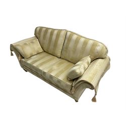Steed Upholstery - two seat traditional shaped sofa, upholstered in cream fabric with stripe pattern, on turned front feet with brass castors, with side cushions and arm covers