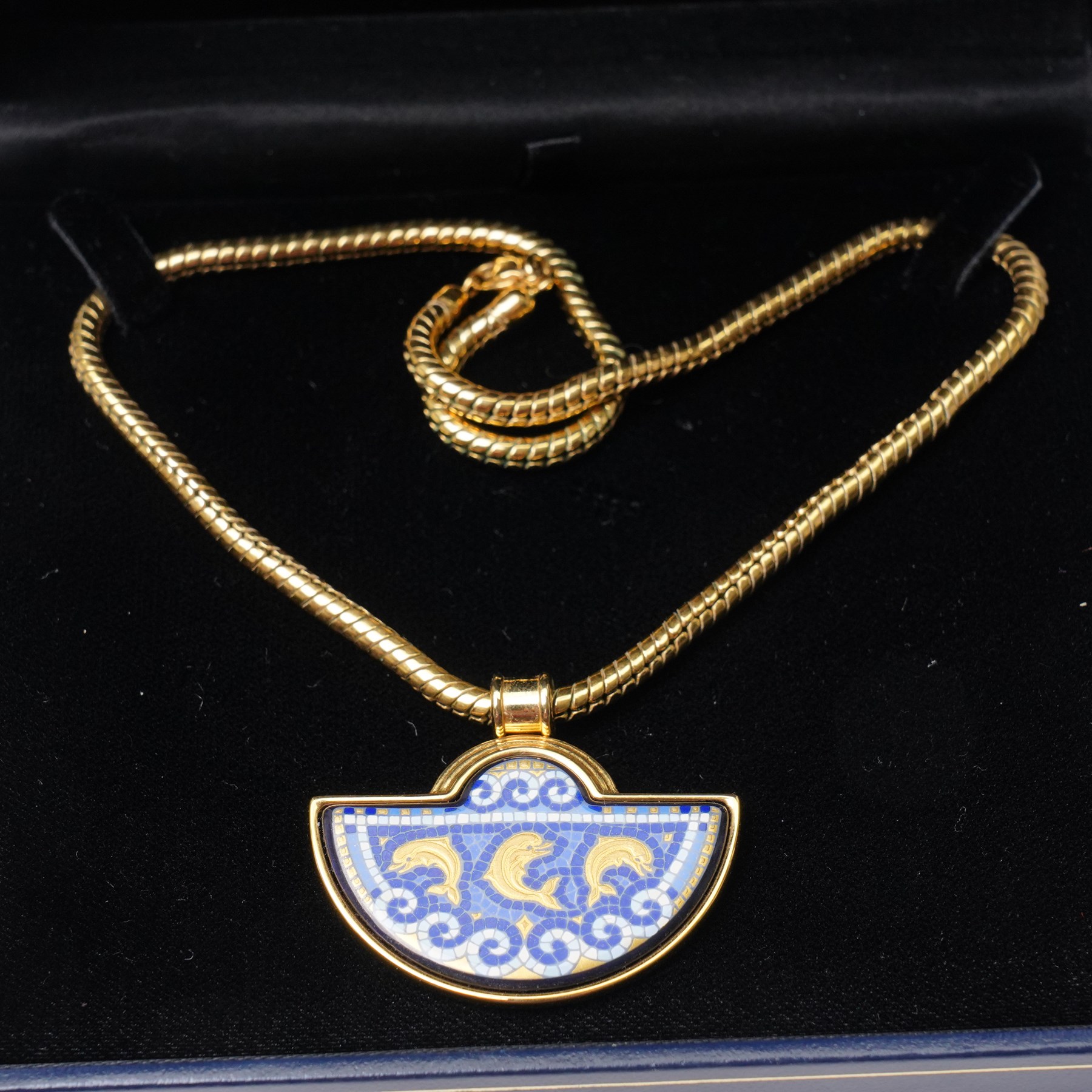 Frey Wille gold plated and enamel suite of jewellery from the Dolphins of Poseidon collection, including a pair of hoop earrings, hinged bangle and pendant on snake chain necklace, all boxed