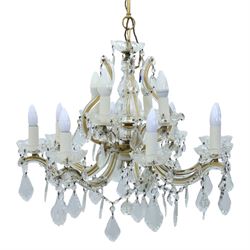 20th century Maria Theresa style twelve branch chandelier, gilt metal frame with scrolling arms clad in moulded glass, the central baluster stem issuing twelve candle sconces with glass drip pans, hung with faceted pendants and swags of cut glass beads 