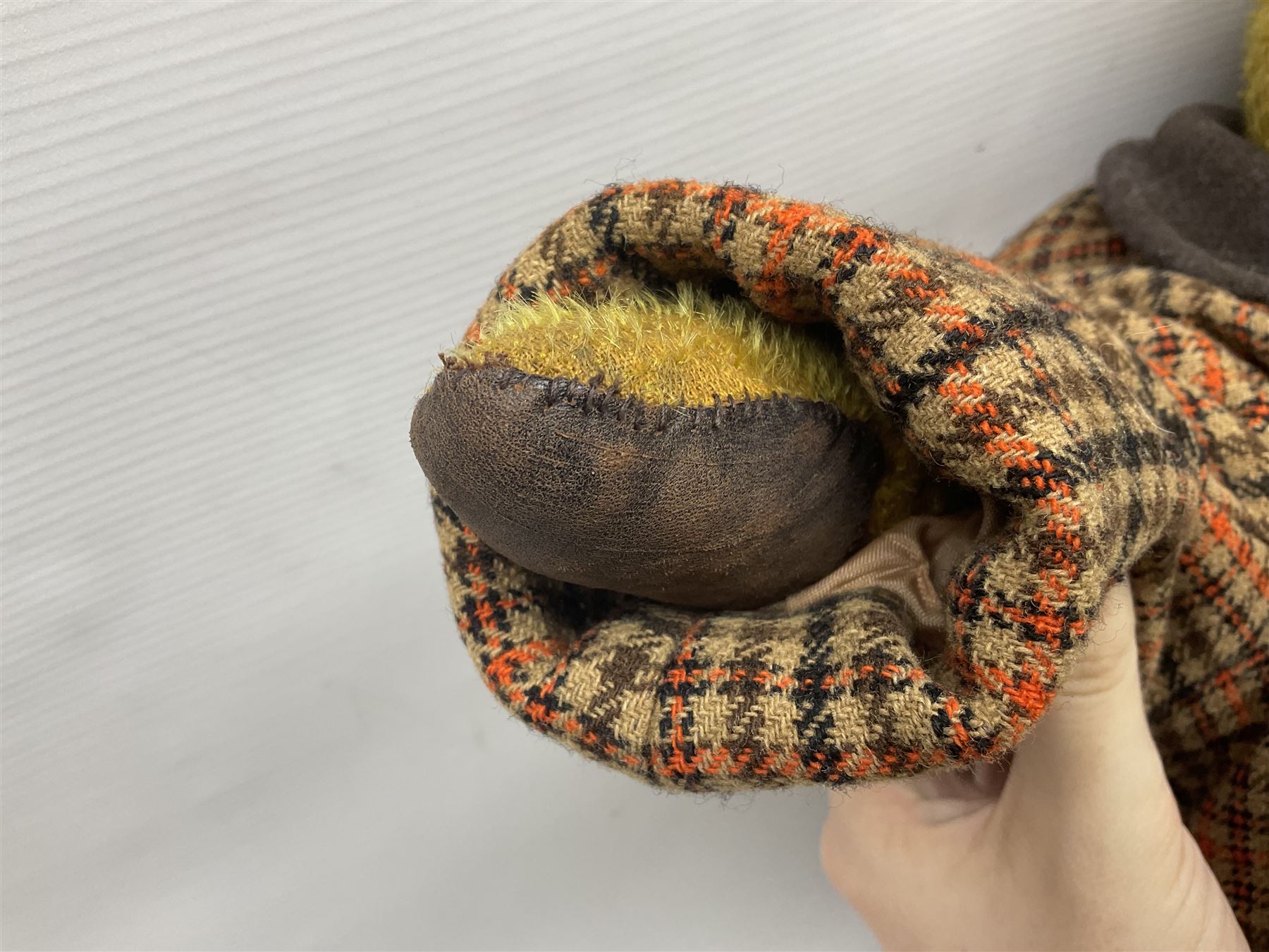 Two early 20th century straw filled jointed teddy bears, first example wearing a tweed jacket bearing Geoffrey Saville label, with leather padded paws and ears, horizontally stitched nose and humpback; second example with applied eyes, vertically stitched nose and faux leather paw pads, both with growler mechanisms, tallest H74cm 