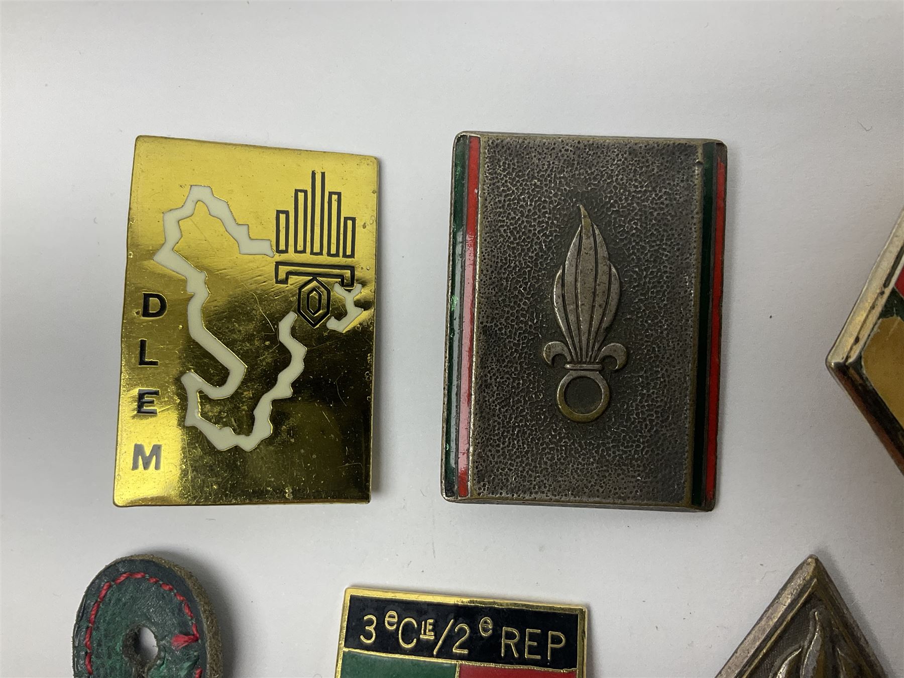 Eleven French Foreign Legion badges including various para, infantry and artillery (some copies)