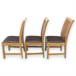 Contemporary oak extending dining table, moulded rectangular top with visible grain and inset extension leaf, pull out extending mechanism, standing on four square legs, accompanied by a set of high slat back chairs with upholstered brown faux leather seats and square tapering supports joined by stretchers