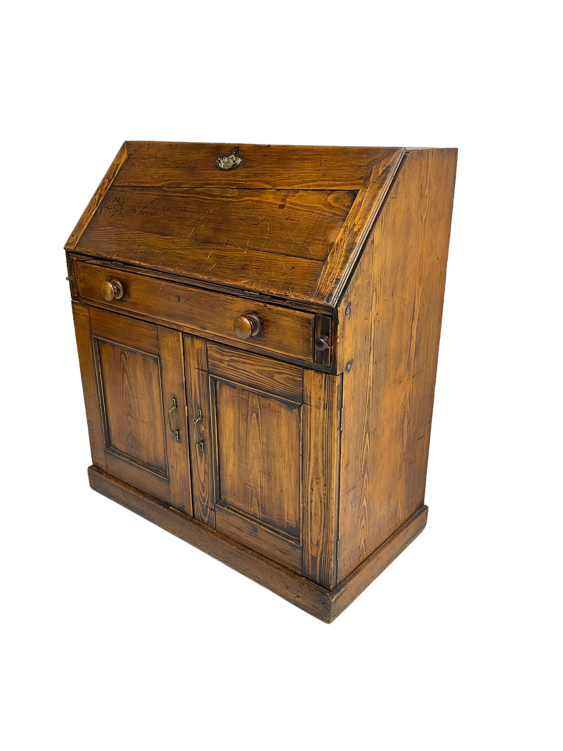 19th century waxed pine bureau, the fall front opening to reveal fitted interior with two drawers and five pigeonholes, base with single drawer over two panelled cupboard doors, on plinth base