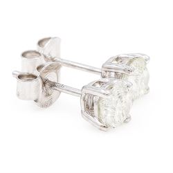 Pair of 18ct white gold diamond stud earrings, each stud set with a round brilliant cut diamond, stamped, total diamond weight approx 0.95 carat