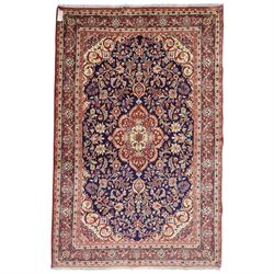 Central Persian Kashan hand-knotted rug, indigo field with central lobed medallion with pe...