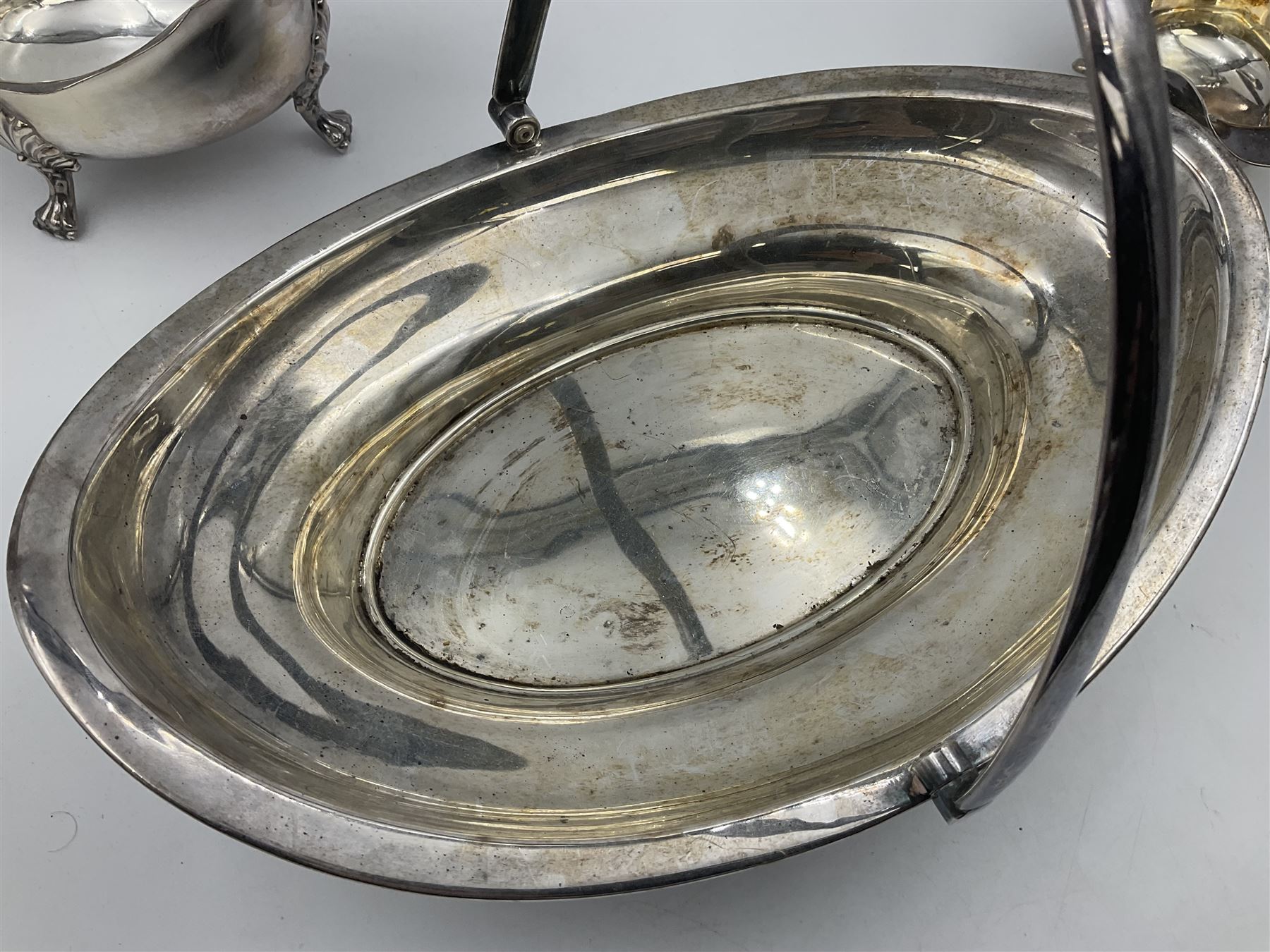Silver plated seven bar toast rack by Mappin & Webb, together with other silver plated items including pair of bottle coasters, swing handled baskets and two sauce boats