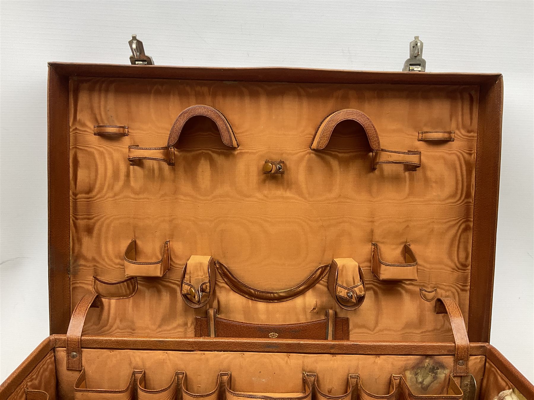 Vintage leather traveling case with monogram to cover, with watered silk lining to interior, and some contents, plus a further vintage travel case, (2)