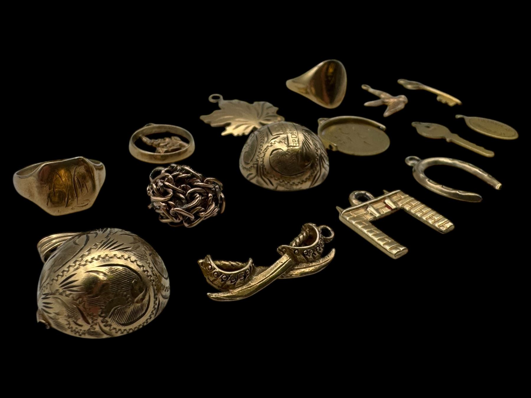 9ct gold charms, including crossed swords, signet ring, horseshoe and leaf, and a 14ct gold fireplace charm