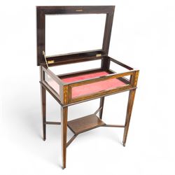 Edwardian rosewood bijouterie cabinet, the hinged rectangular top with line inlay enclosing a velvet lined interior, upon slender tapering legs inlaid with satinwood foliate marquetry decoration, with stretchers united by an under tier, raised on castors 