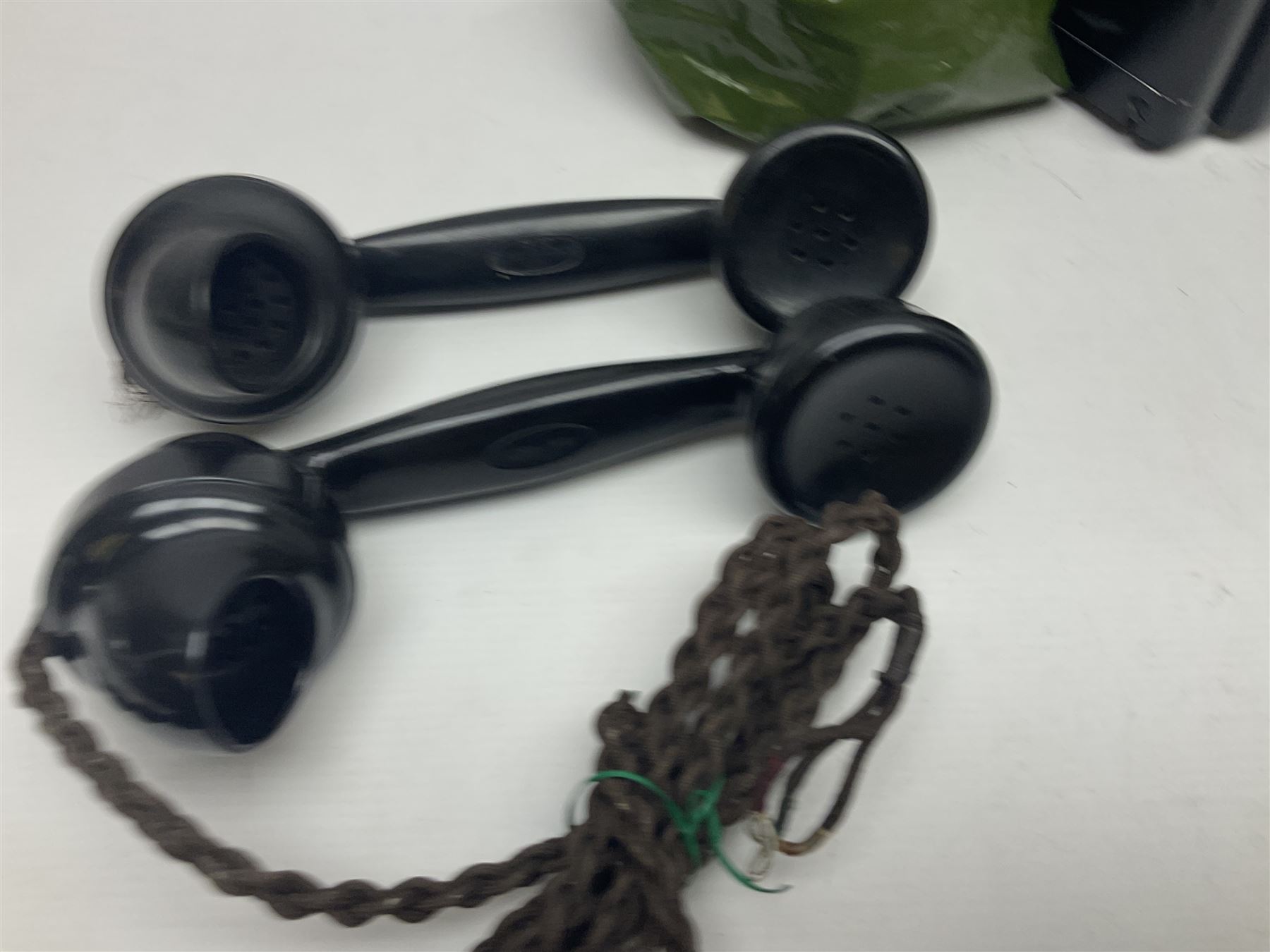 Collection of phone headsets, including GPO bakelite examples, together with other telephone parts 