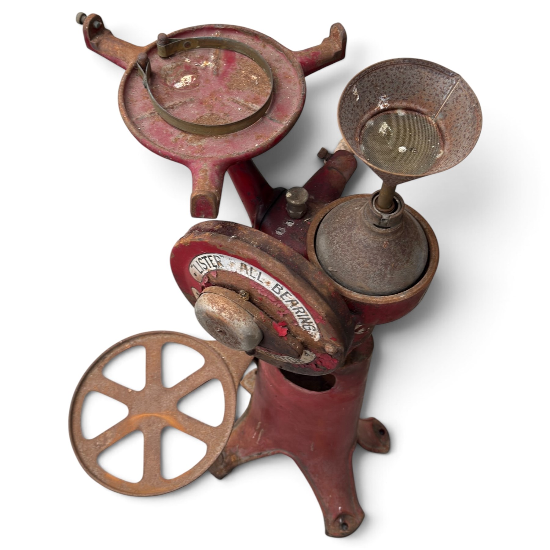 Two early 20th century dairy equipment items: Waide & Sons, Leeds – oak barrel butter churn with iron bands, later converted to electric operation, on trestle stand (W71cm H115cm); Lister – ‘Ball Bearing’ cast iron cream separator, with hopper and foot pedal, in red-painted finish (W47cm H49cm)