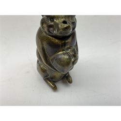 Victorian novelty brass vesta case modelled in the form of a pig holding a money bag, together with a silver vesta, hallmarked 
