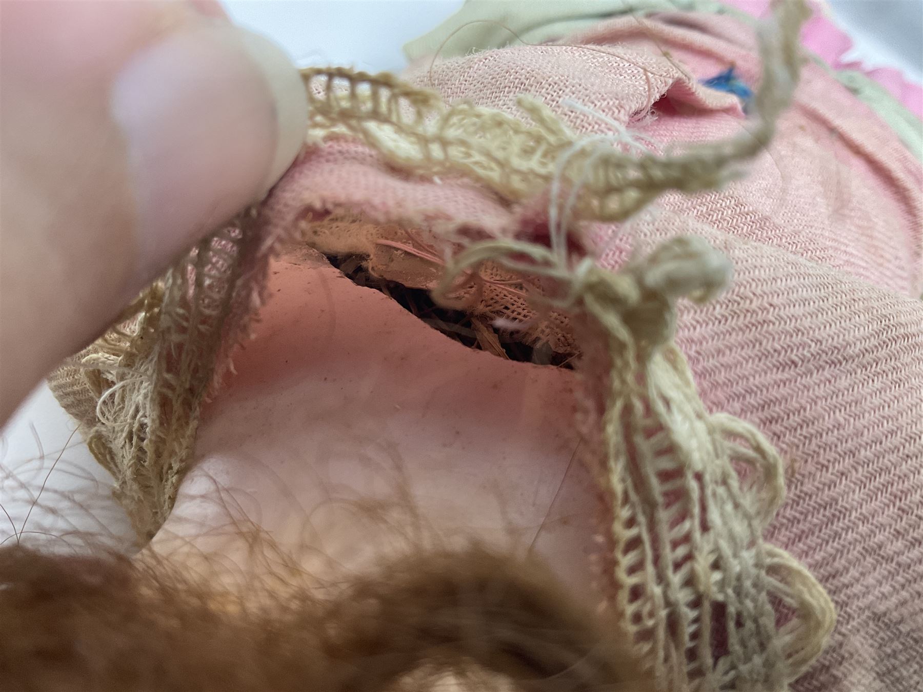 Victorian wax shoulder head doll with applied hair, inset glass eyes and jointed body with composition lower limbs; faded pink dress H35cm